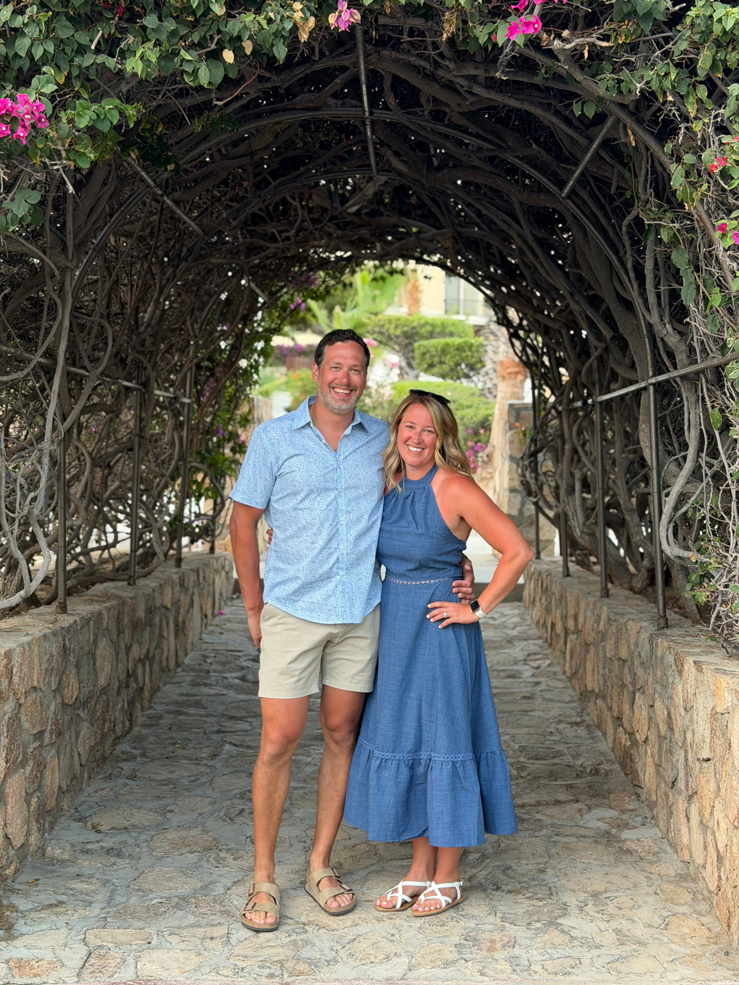 Andrew and Stacy Gissal under a bougainvillea archway